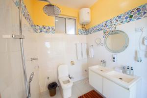 a bathroom with a toilet and a sink and a shower at Double A Nungwi Beach Hotel - Beach Front in Nungwi +23 photos