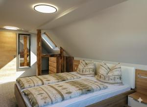 a bedroom with a large bed with pillows at Ferienwohnung Dreams in Hasselfelde