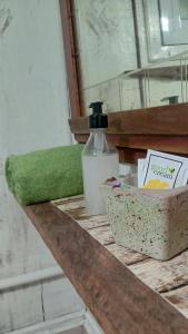 a bathroom counter with a bottle of soap and a box of soap at Cabaña Agustina in El Soberbio