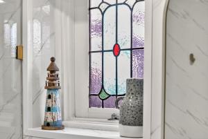 a window with a christmas ornament on a window sill at The Wharf House Goolwa in Goolwa +15 photos