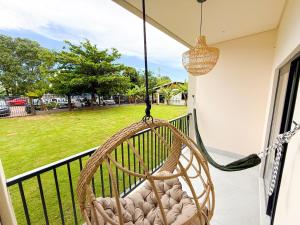 a hammock on a balcony with a view of a park at Pousada Girassol in Bonito
