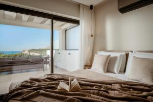 a bedroom with a bed with a book on it at Sunset Dream Luxury Villa in Keri +41 photos