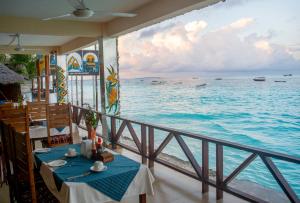a view of the ocean from a balcony of a restaurant at Double A Nungwi Beach Hotel - Beach Front in Nungwi