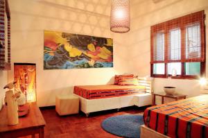 ein Schlafzimmer mit 2 Betten und einem Wandgemälde in der Unterkunft Guesthouse MALAGUETA INN I & II in Maputo