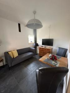 a living room with a couch and a table at De Schuure 't Voorde in Winterswijk in Winterswijk