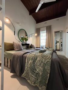 a bedroom with a bed and a large mirror at Calitzdorp Self-Catering Guesthouse - Oudehuis in Calitzdorp