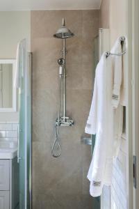 a bathroom with a shower with white towels at Fontänens Bed & Breakfast in Trelleborg