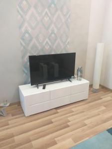 a flat screen tv sitting on top of a white cabinet at Elizabeth Apartman 2 in Hévíz