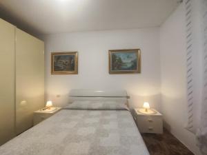 a bedroom with a bed and two lights on the sides at Margherita in Seriate