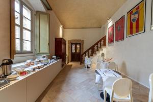 a large room with a long counter with tables and chairs at Palazzo Sbaraglini in Assisi