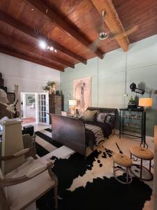 a living room with a couch and a table at Calitzdorp Self-Catering Guesthouse - Oudehuis in Calitzdorp