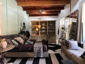 a living room with a couch and a table at Calitzdorp Self-Catering Guesthouse - Oudehuis in Calitzdorp