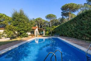 a swimming pool in front of a house at Spacious Countryside Costa Brava Relax in Sils