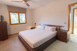 a bedroom with a bed and a window at Spacious Countryside Costa Brava Relax in Sils +24 photos