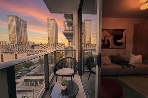 a balcony with a couch and a view of a city at Stylish Condo at The Crosby in Miami