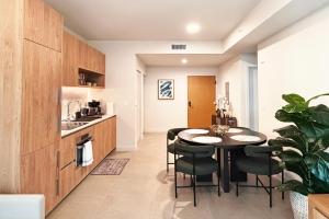 a kitchen and dining room with a table and chairs at Stylish Condo at The Crosby in Miami