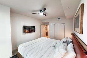 a bedroom with a bed and a ceiling fan at Stylish Condo at The Crosby in Miami +18 photos