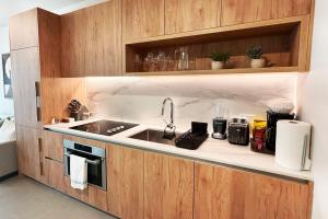 a kitchen with a sink and a microwave at Stylish Condo at The Crosby in Miami