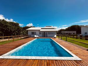 a swimming pool on a deck with a house at vila sua casa 2 in Santo André