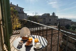 a table with food and drinks on a balcony at Palazzo Sbaraglini in Assisi +76 photos