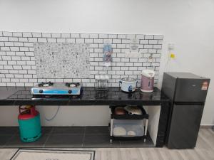 a toy kitchen with a table and a refrigerator at Akiera Homestay #MELAYU ONLY in Pelabuhan Kelang