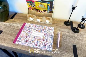 a table with a book and shoes on it at Driftwood Bay in Fleetwood