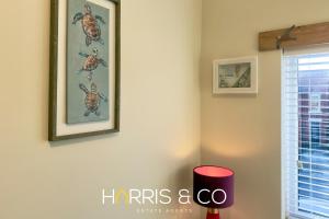 a living room with a picture on the wall at Driftwood Bay in Fleetwood +36 photos