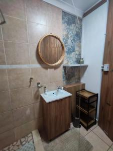 a bathroom with a sink and a mirror at Flat 1 in Kimberley +19 photos