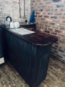 a wooden counter in a room with a brick wall at Revenir in Middelburg