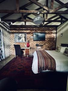 a bedroom with a bed and a desk and a tv at Revenir in Middelburg