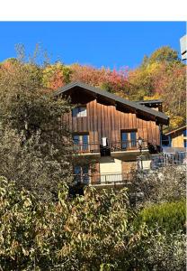 a house on a hill with trees at Appartement BOZEN - 100M2- 6 personnes - Bozel - Vallée de Courchevel in Bozel