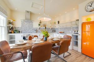 a kitchen with a dining room table and chairs at 4 Bed in Cromer oc-2117 in Cromer