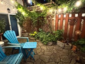 two blue chairs sitting on a patio at night at Montreal Hideaway in a Residential area in Montreal