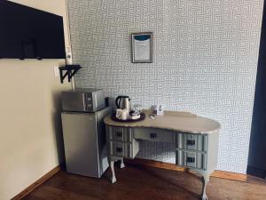 a kitchen with a small table next to a refrigerator at Revenir in Middelburg