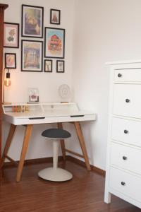 a white desk with a stool next to a dresser at Little Oasis Apartment in Zgornje Gorje