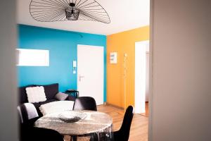 a living room with a table and a couch at Have a Cosy, Élégance in Grand-Fort-Philippe +15 photos