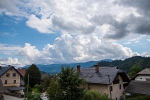 a view of a town with houses and mountains at Little Oasis Apartment in Zgornje Gorje