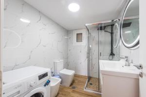 a bathroom with a shower and a sink and a toilet at Siar The Small Villa by PikHost in Borsh +22 photos