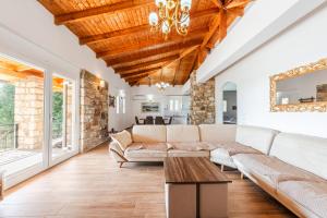 a living room with a couch and a table at Siar The Small Villa by PikHost in Borsh