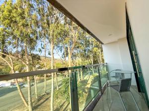 a balcony with a table and chairs and trees at Hotel JD in Taquaritinga do Norte