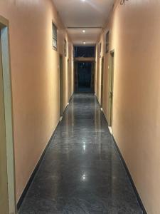 an empty hallway of a building with a long corridor at SriI Kanya Lodge in Mandapeta