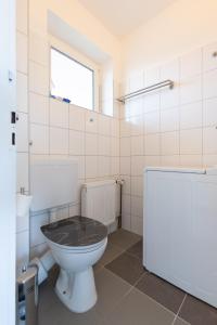 a bathroom with a toilet and a window at Exclusive Home Feeling Flat in Ratingen +22 photos