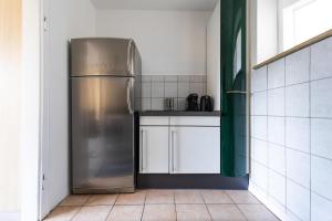 a kitchen with a stainless steel refrigerator in a room at Exclusive Home Feeling Flat in Ratingen