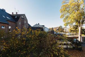 a house and a tree with yellow flowers in the foreground at Exclusive Home Feeling Flat in Ratingen