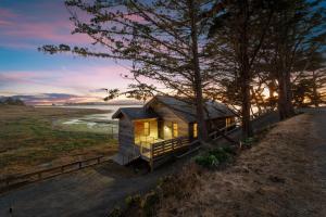 a tiny house on the beach at sunset at Bodega Bay - Ocean View, Fireplace & BBQ in Bodega Bay
