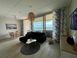 a living room with a couch and a table at Marina Resort A9 in Kalajoki