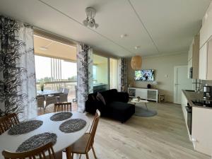 a living room with a table and a couch at Marina Resort A9 in Kalajoki