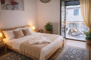 a bedroom with a large bed and a balcony at MARY HOUSE Central Station Large Apartment in Sondrio