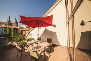 a table with a umbrella and a table cloth at Boutique Hotel Bristol in Košice