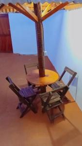 a table and two chairs and a table with an umbrella at BELL MAR CHALÉs 03 in Luis Correia +3 photos